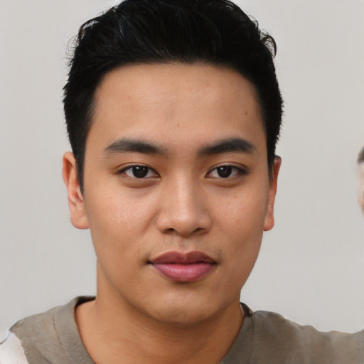 Joyful asian young-adult male with short  black hair and brown eyes