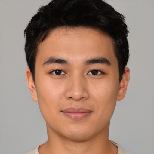 Joyful asian young-adult male with short  black hair and brown eyes