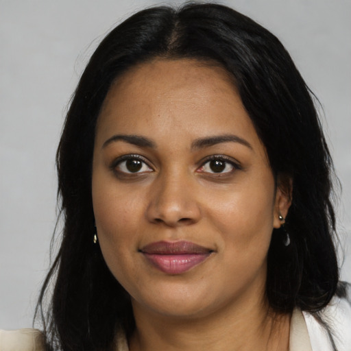Joyful black young-adult female with medium  brown hair and brown eyes