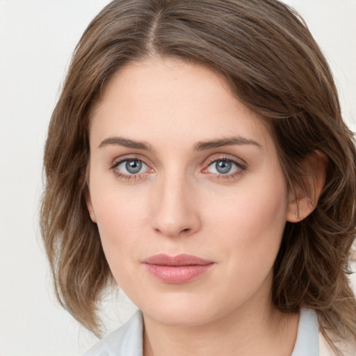 Joyful white young-adult female with medium  brown hair and blue eyes