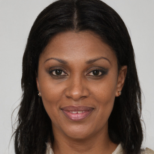 Joyful black adult female with long  brown hair and brown eyes