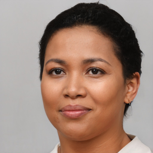 Joyful latino young-adult female with short  brown hair and brown eyes