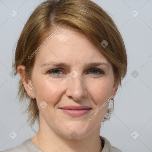 Joyful white adult female with medium  brown hair and blue eyes