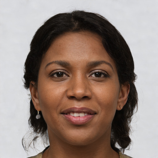 Joyful black young-adult female with medium  brown hair and brown eyes