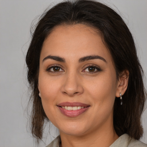 Joyful white young-adult female with medium  brown hair and brown eyes