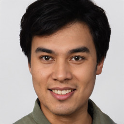 Joyful asian young-adult male with short  black hair and brown eyes