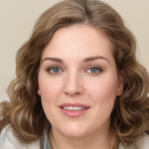 Joyful white young-adult female with medium  brown hair and green eyes