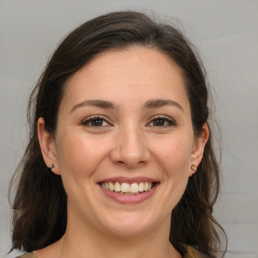 Joyful white young-adult female with medium  brown hair and brown eyes