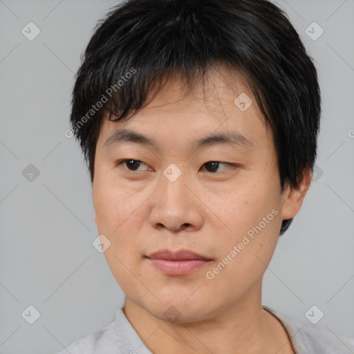 Joyful asian young-adult male with short  brown hair and brown eyes