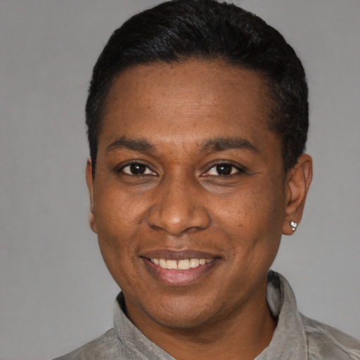 Joyful latino adult male with short  black hair and brown eyes