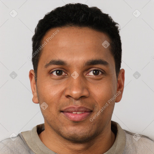 Joyful black young-adult male with short  black hair and brown eyes