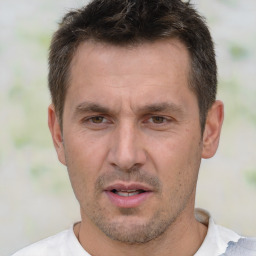 Joyful white adult male with short  brown hair and brown eyes