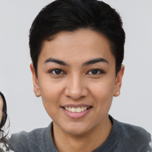 Joyful asian young-adult female with short  brown hair and brown eyes