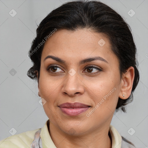 Joyful latino adult female with medium  brown hair and brown eyes