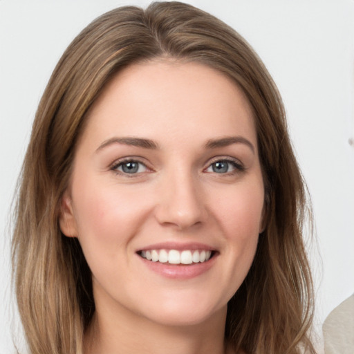 Joyful white young-adult female with long  brown hair and grey eyes