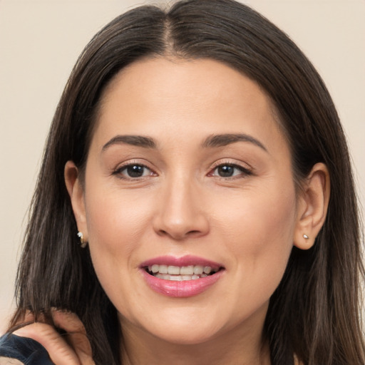 Joyful white young-adult female with long  brown hair and brown eyes