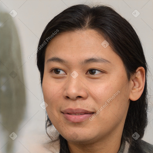 Joyful asian young-adult female with medium  brown hair and brown eyes