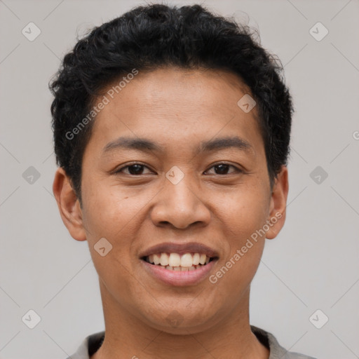 Joyful latino young-adult male with short  black hair and brown eyes