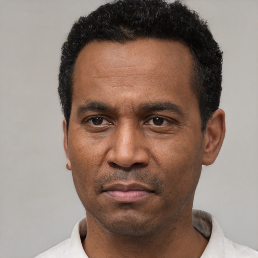 Neutral latino adult male with short  black hair and brown eyes