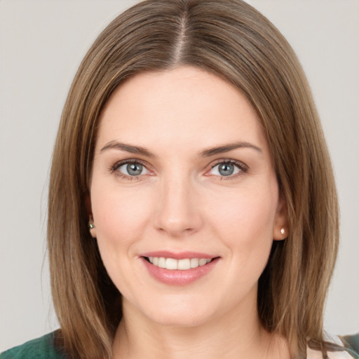 Joyful white young-adult female with medium  brown hair and green eyes