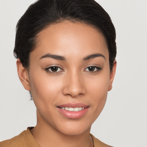 Joyful latino young-adult female with short  brown hair and brown eyes