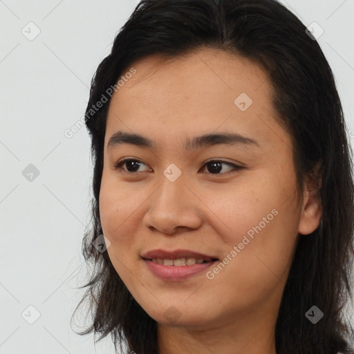 Joyful latino young-adult female with long  brown hair and brown eyes