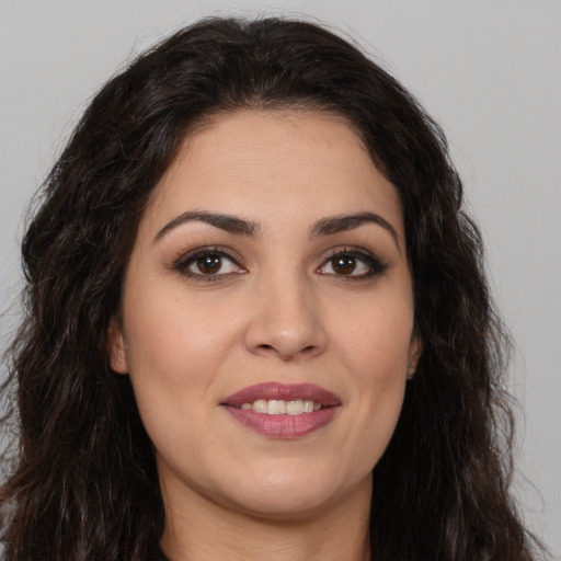 Joyful white young-adult female with long  brown hair and brown eyes