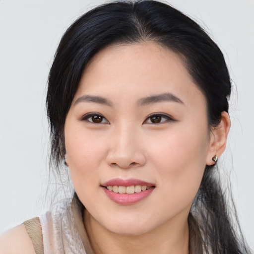 Joyful asian young-adult female with long  brown hair and brown eyes