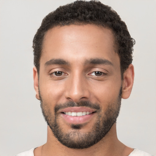 Joyful white young-adult male with short  black hair and brown eyes