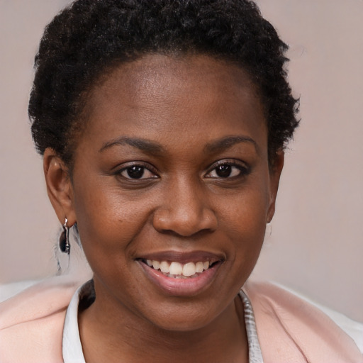 Joyful black young-adult female with short  brown hair and brown eyes