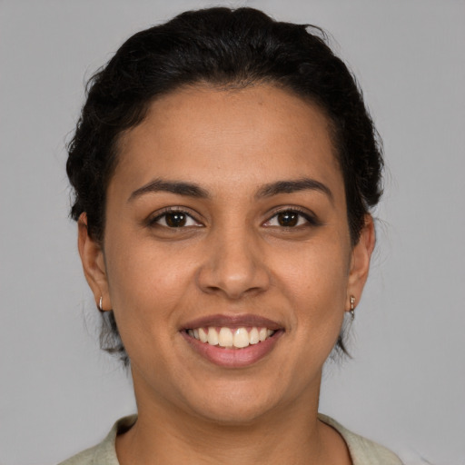 Joyful latino young-adult female with short  brown hair and brown eyes