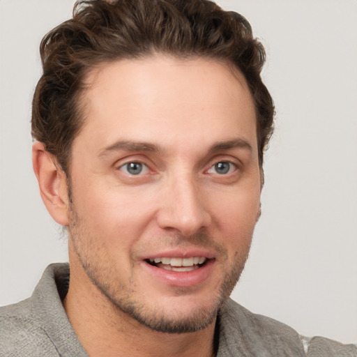 Joyful white adult male with short  brown hair and grey eyes