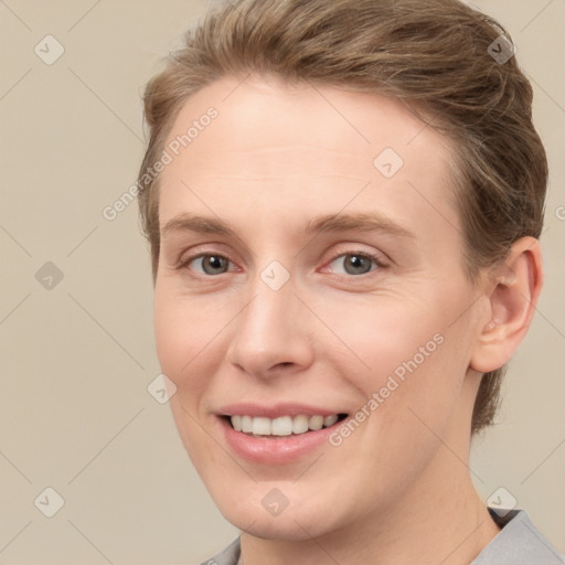 Joyful white young-adult female with short  brown hair and grey eyes