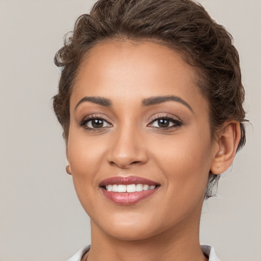 Joyful white young-adult female with short  brown hair and brown eyes