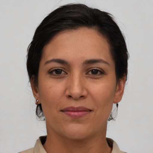 Joyful latino young-adult female with medium  brown hair and brown eyes