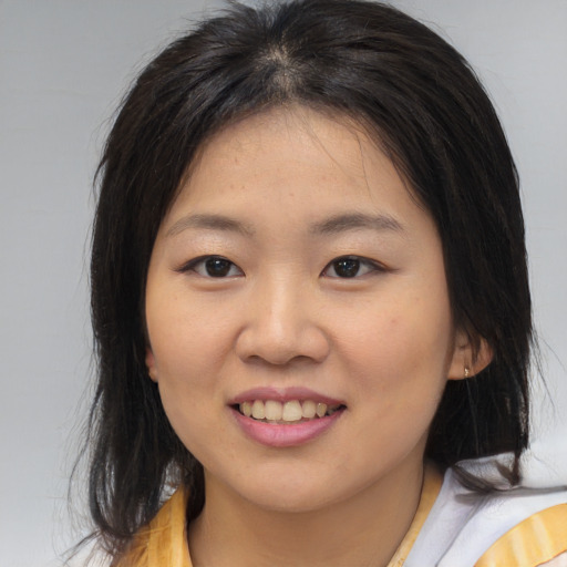 Joyful asian young-adult female with medium  brown hair and brown eyes