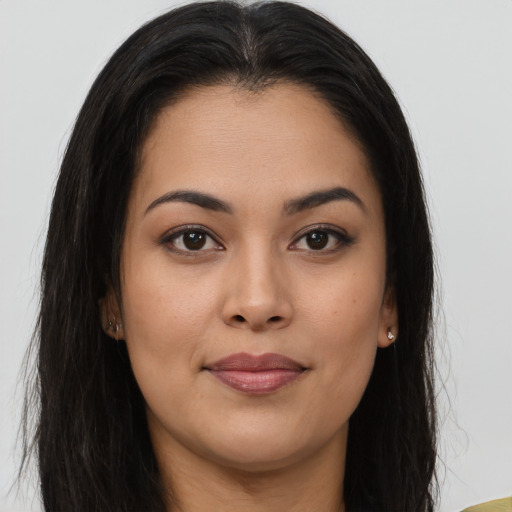 Joyful asian young-adult female with long  brown hair and brown eyes