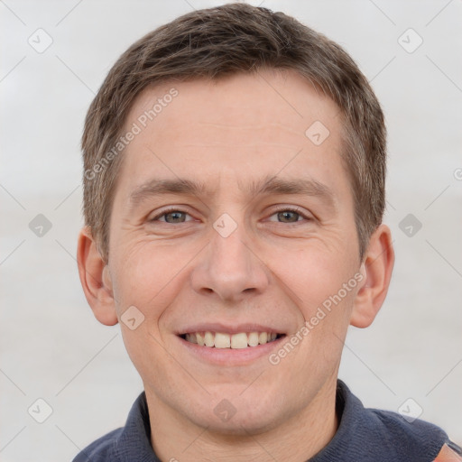 Joyful white adult male with short  brown hair and grey eyes