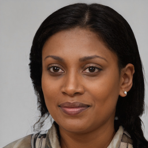 Joyful black young-adult female with medium  brown hair and brown eyes