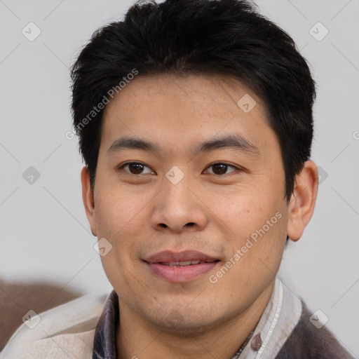 Joyful asian young-adult male with short  black hair and brown eyes