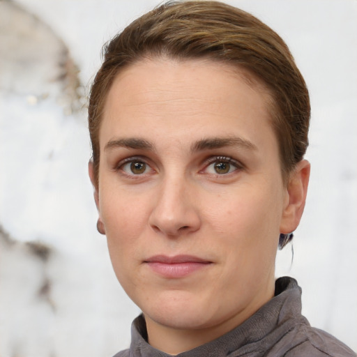 Joyful white young-adult female with short  brown hair and grey eyes