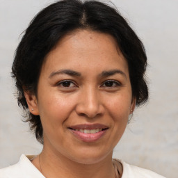 Joyful white adult female with medium  brown hair and brown eyes