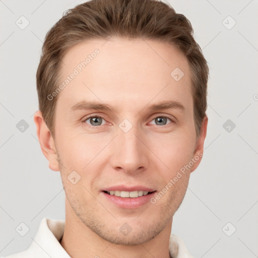 Joyful white young-adult male with short  brown hair and grey eyes