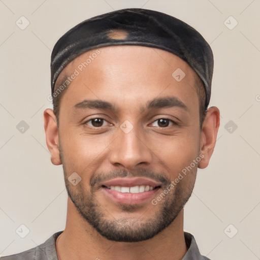 Joyful white young-adult male with short  black hair and brown eyes