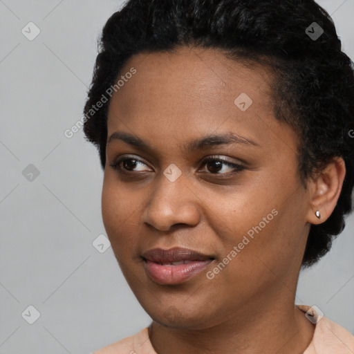 Joyful black young-adult female with short  black hair and brown eyes