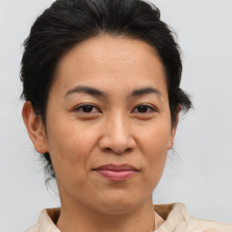 Joyful asian adult female with medium  brown hair and brown eyes