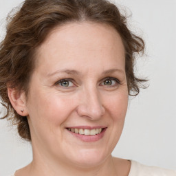 Joyful white adult female with medium  brown hair and grey eyes