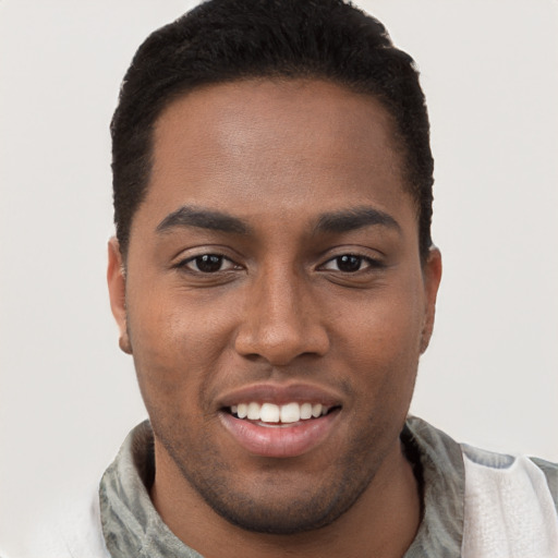 Joyful black young-adult male with short  brown hair and brown eyes