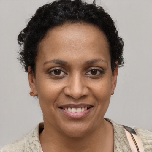 Joyful black young-adult female with short  brown hair and brown eyes