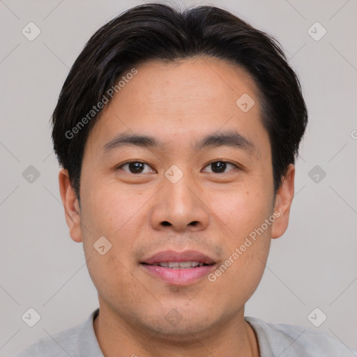 Joyful asian young-adult male with short  brown hair and brown eyes